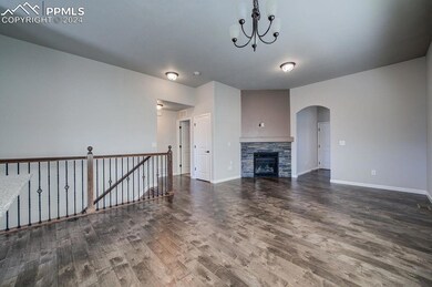 Unfurnished living room with a fireplace, hardwood