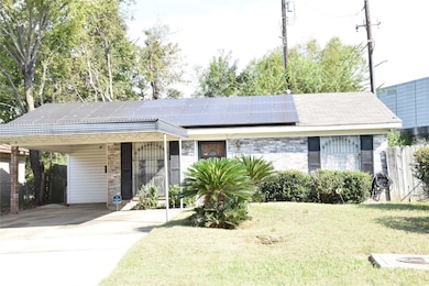 Ranch-style home featuring a front yard, solar pan