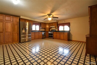 Kitchen featuring custom  cabinets, appliances with stainless steel finishes, pantry