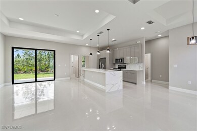 Kitchen with gray cabinets, a raised ceiling, visi