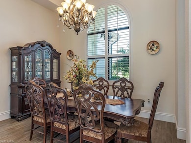 Dining area featuring a chandelier and hardwood / 