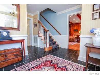 This welcoming foyer has slate tile flooring