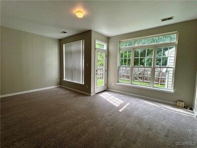 Unfurnished room with plenty of natural light and carpet flooring