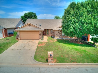 Single story home with a front yard and a garage
