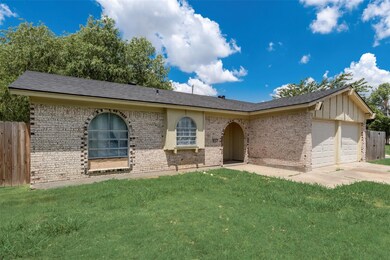 Single story home with a garage and a front yard