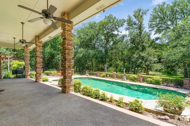 Porch stretching the width of the pool with sweeping views, ceiling fans.  The perfect outdoor dining space.