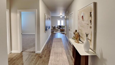 Hallway featuring dark wood-style floors