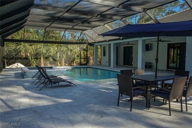 View of pool with a lanai, a patio area, a pool wi