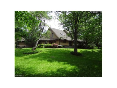 View of the rear of the home. The deck wraps aroun