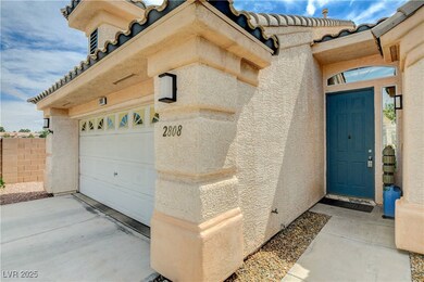 Doorway to property with a garage, a tiled roof, d