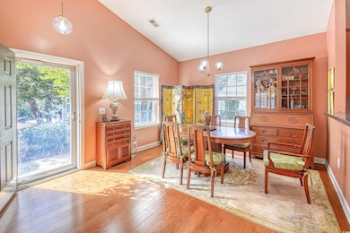 Dining area with high vaulted ceiling, an inviting