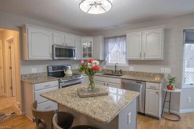 The kitchen has a center island with seating.