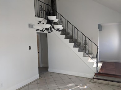 Living area has vaulted ceiling and ceramic tile f