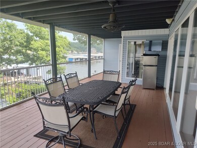 More of screened-in deck looking to dock with included slip.  Furniture, refrigerator and TV are included.