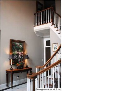 Two foyer with curved staircase.  There is a secon