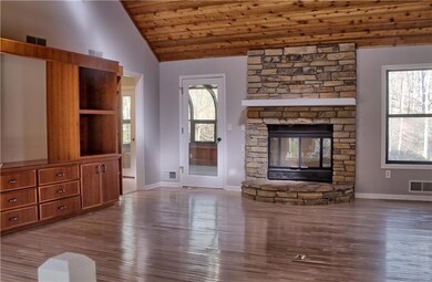 Unfurnished living room featuring baseboards, loft