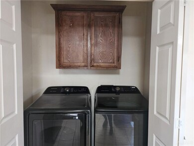 Washroom featuring washing machine and clothes dryer and cabinet space