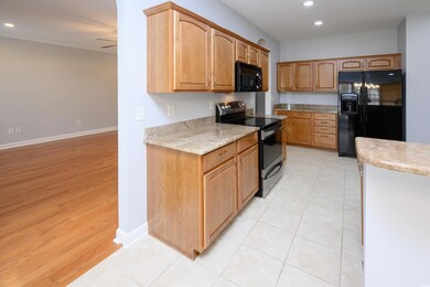 Kitchen with black appliances, recessed lighting, 