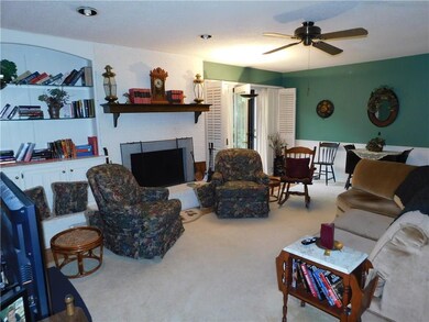 Den with fireplace, built-in shelves & cabinets; a