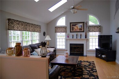 Great room with vaulted ceiling, ceiling fan and f