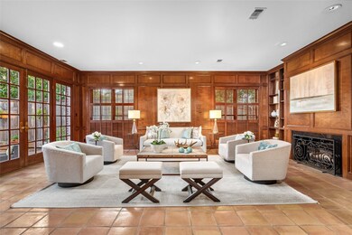 Living room features gas log fireplace flanked by