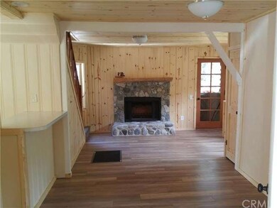 Living room. Kitchen to left, half bath to right.