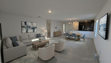 Living room featuring light tile patterned floors and recessed lighting
