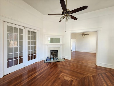 Unfurnished living room with a fireplace and ceiling fan