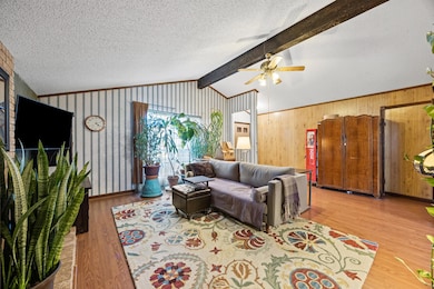 Living room with light wood finished floors, a te