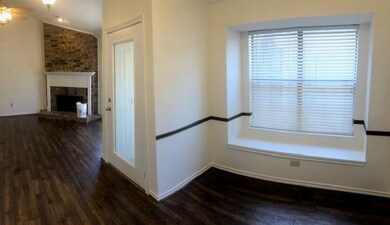 Hallway with lofted ceiling and dark hardwood / wo
