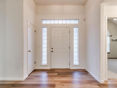 Entry to living room and hallway to 2 guest rooms