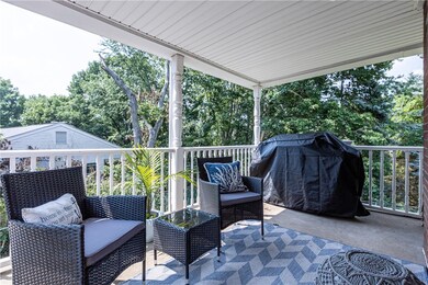 Relax on the covered side porch, off kitchen overl