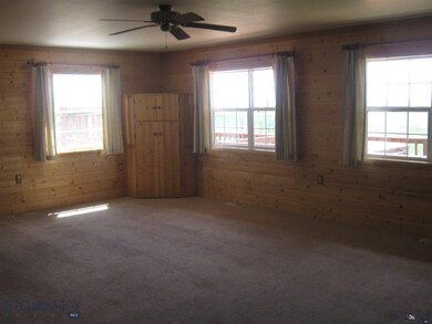 Large Livingroom with many windows taking in the v