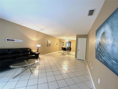 Open concept living area. Storage closet under stairs to the right.