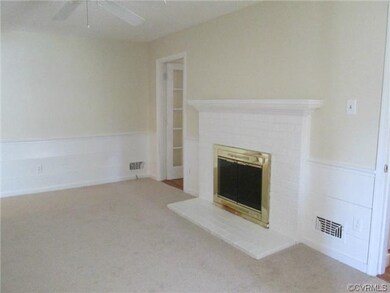 Family Room has wall to wall carpet and cozy woodb