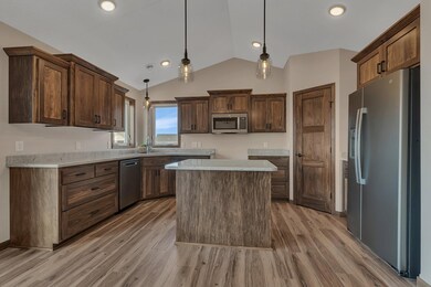 Double Kitchen windows for natural light, granite kitchen countertops, and a corner pantry