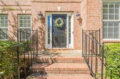 Doorway to property featuring brick siding