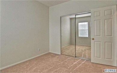 Another bedroom with mirrored wardrobe doors