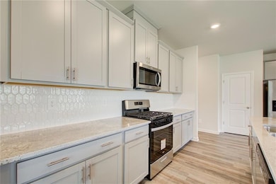 Kitchen featuring appliances with stainless steel