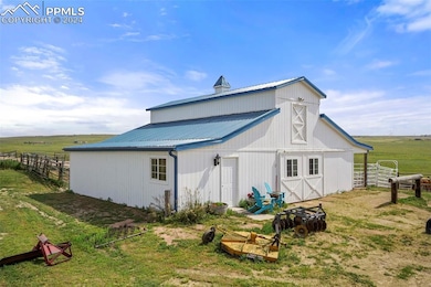 View of outbuilding featuring a rural view