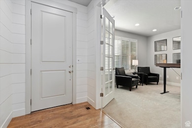 Foyer entrance featuring recessed lighting and wood finished floors