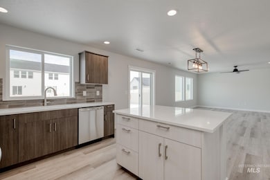 Kitchen featuring plenty of natural light, hanging light fixtures, ceiling fan, light wood-style flooring, and recessed lighting