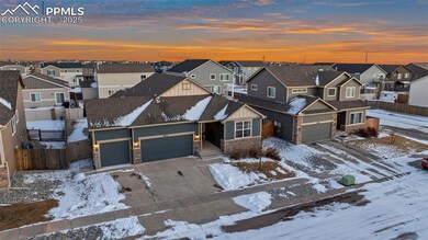 Aerial view of house featuring a three-car garage 