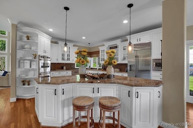 Kitchen with tasteful backsplash, glass insert cab