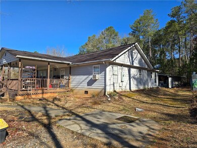 View of side of home featuring crawl space, covered porch, and cooling unit