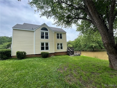 Rear view of house with a lawn, a deck, and crawl