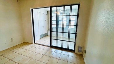 Doorway to outside featuring tile patterned floors and baseboards