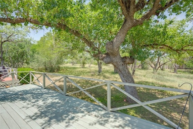 Wooden deck featuring view of scattered trees