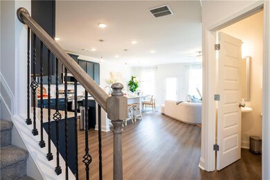 Staircase with hardwood / wood-style floors and ce