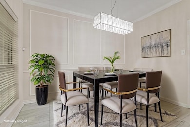 Dining room featuring a chandelier, crown molding,